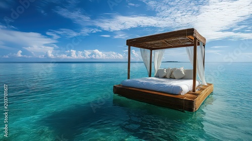 Luxury floating bed with canopy on calm turquoise tropical ocean waters under a sunny blue sky