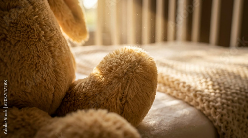Empty vintage white baby crib with a stuffed bunny bathed in warm morning sunbeams and dust motes. Perfect for nostalgic nursery interiors and parenting lifestyle storytelling.