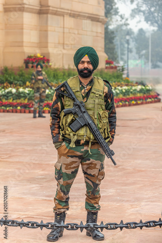 Sikh soldier in camouflage uniform standing guard with rifle at India Gate, New Delhi, India, 29 Jan 2024