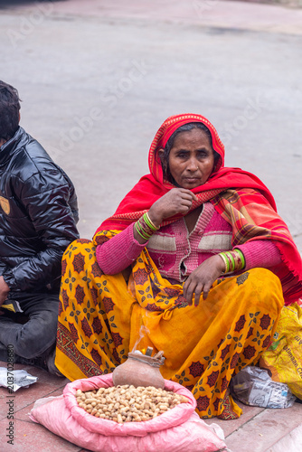 Woman in colourful traditional attire selling peanuts on the street, India, Delhi, India, 29 Jan 2024