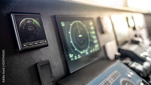 Digital compass navigation and depth monitor on dashboard of marine boat. Nautical vessel control system in wheelhouse or ship captain bridge. Modern boating technology