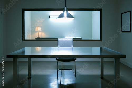 Interrogation room one way mirror metal table chair lamp empty interior