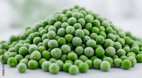 Heap of frozen organic green peas with ice crystals