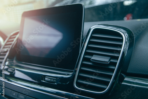 Foto Close up of modern car interior with black leather seats and air conditioning