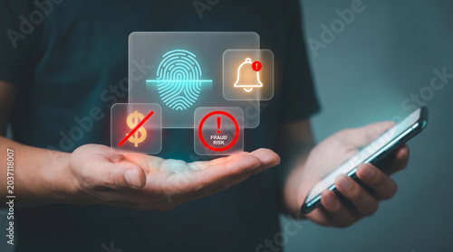 Person Holds Smartphone with Holographic Fraud Risk Dashboard Showing Fingerprint Scan to Detect Suspicious Activity, Trigger Security Alerts, and Block Unauthorized Transactions