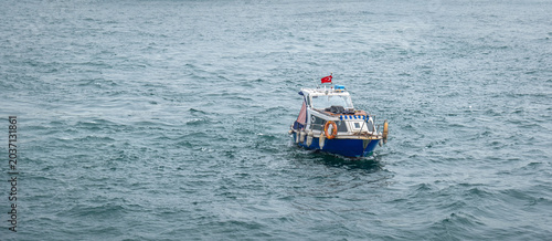 small fishing boat in the sea, amidst the waves.