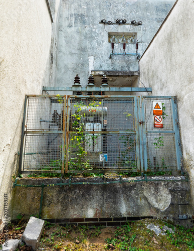 Abandoned transformer station near an old building