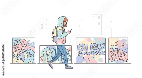 Young woman with backpack walking past graffiti art on city street, urban style