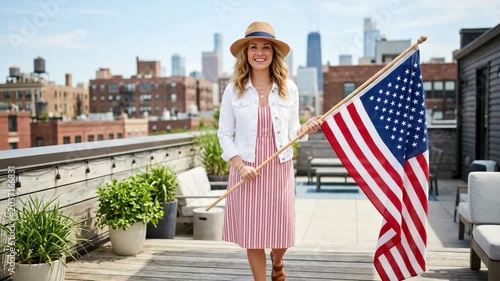 Woman Holding American Flag on Rooftop: A smiling woman in a straw hat and summer dress stands on a city rooftop, holding the American flag.