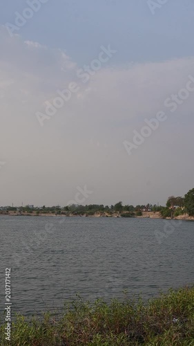 Vertical reservoir landscape with calm water and shoreline video