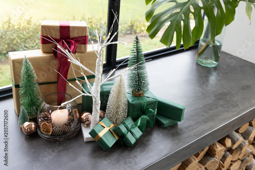 Bild auf Leinwand Holiday display sitting on stone windowsill with wrapped kraft gifts, bottlebrus