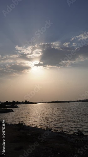 Vertical sunset lakescape with dramatic clouds video