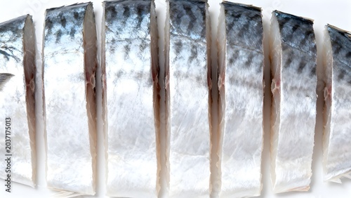 raw mackerel fish cut into clean slices, arranged neatly on a white background. Ready for cooking.