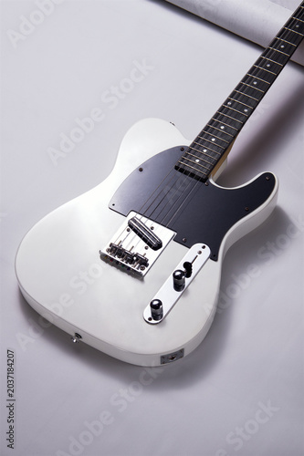 Angled View of a Classic White Solid Body Electric Guitar with Black Pickguard