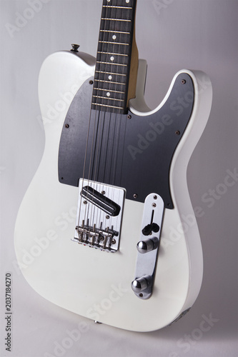 Guitar SideClose-Up of White Electric Guitar Body Showing Bridge, Pickups, and Knobs