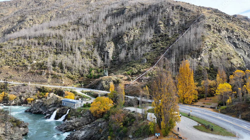 Fototapeta premium Aerial View of Kawarau River with Hydroelectric Station and Autumn Foliage