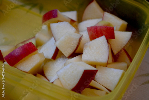 Apple cubes in container, representing food preparation, storage, and healthy eating.