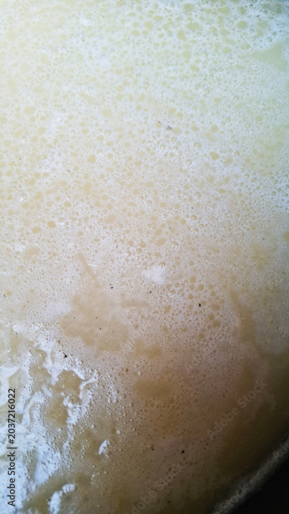 Fototapeta premium close up of a foam appearing at the opening of wastewater from the food processing industry, water texture