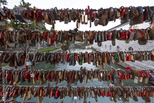 LJUBLJANA, SLOVENIA, JULY 15, 2024 - Butchers' Bridge in Ljubljana Slovenia, famous for the thousands of love locks attached to its balustrades.