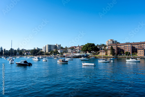 Fotografie Manly Beach harbor with boats and waterfront buildings in Sydney, Australia