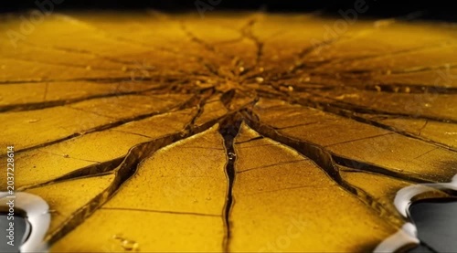 A close-up shot of a cracked food dessert in a plate indoors