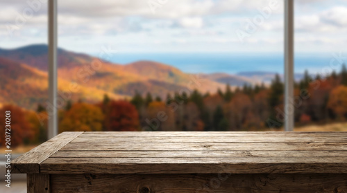 Wooden table mockup with autumn mountain landscape background