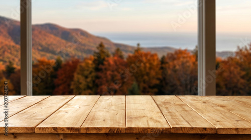 Wooden table with blurred autumn mountain landscape background