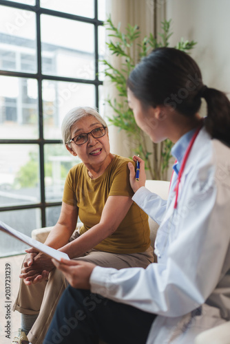 Doctor reassuring senior patient during healthcare consultation