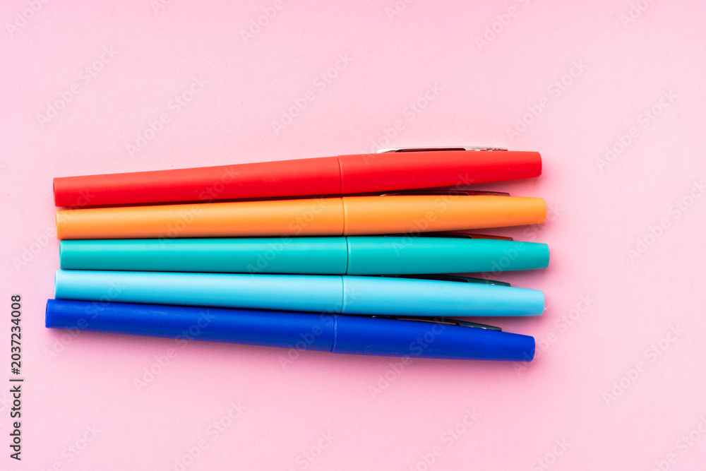 Fototapeta premium coloured rainbow pens on a pink background