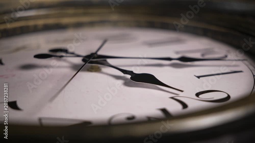 Timelapse macro static shot of an antique clock face. Watch hands spin rapidly across roman numerals illustrating the fast passage of time.