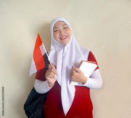 Young College Girl Wear Rucksack Showing Support For Her National Football Team With Little Flag While Holding Books
