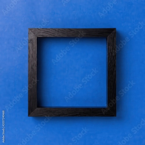 Minimalist Black Wooden Square Picture Frame on Vibrant Blue Background with Copy Space and Design Space, Modern Mockup for Graphic Presentation, Commercial Branding Template