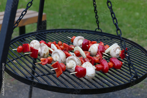 Mushrooms, paprika and cherry tomatoes shashliks on a grill