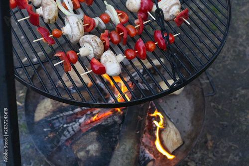 Mushrooms, paprika and cherry tomatoes shashliks on a grill