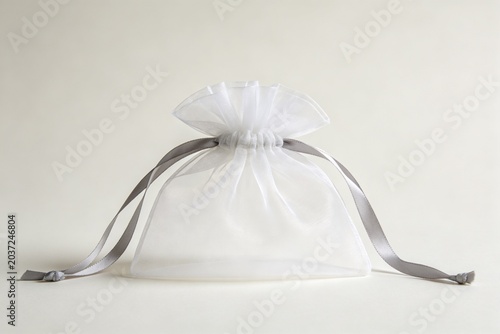 White organza drawstring gift bag with gray ribbon
