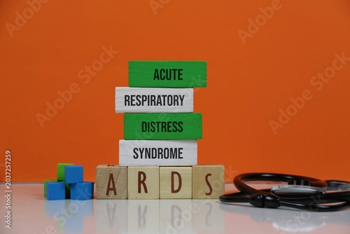 Acute Respiratory Distress Syndrome (ARDS) Concept With Wooden Blocks And Stethoscope On Orange Background