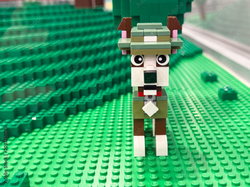 Obraz premium Lego dog made from bricks on green baseplate