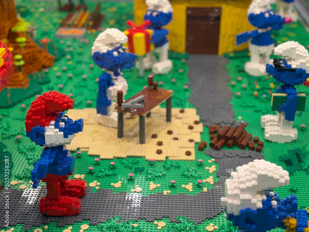Obraz premium Lego smurfs in park with gift and picnic table