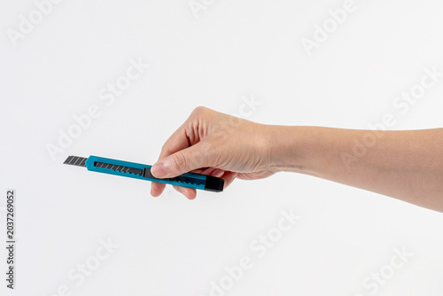 A blue cutter, an office supply, in hand on white background.