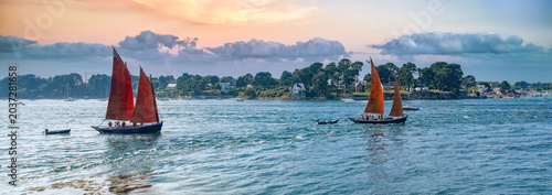 Old boat at the Ile-aux-Moines island, with red sails, traditional boat in the Morbihan gulf, Brittany