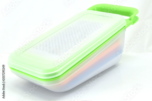 Quadro su tela Side View of Multifunction Kitchen Grater Container, Side angle of a multifunction vegetable grater container with colorful storage layers isolated on white background for kitchen product catalogs