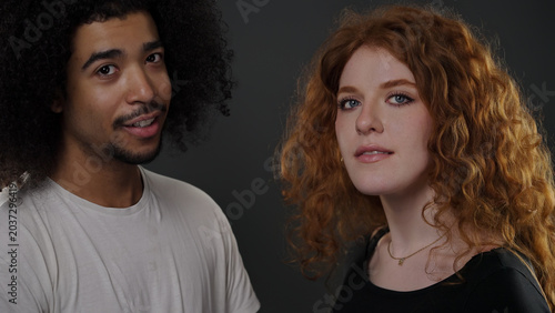 Vászonkép Diverse young couple posing for a half length portrait shot