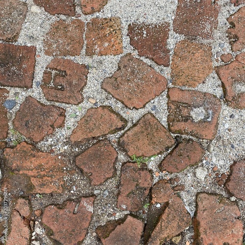 Vintage brick pavers walkway texture background. Ancient red clay bricks path pavement with sand joints for architectural design backdrop.