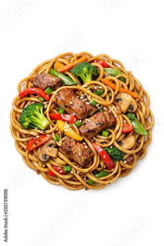 Beef stir fry with noodles and colorful vegetables on white background.