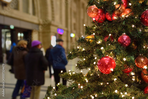 Christmas trees with colorful balls reflecting night illumination. Shallow DOF photo.