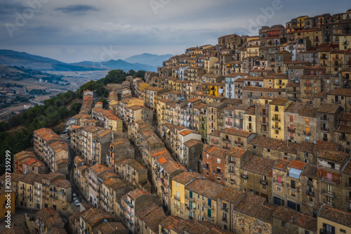 Sunrise view of the rooftops of Gangi with morning fog. Sicily, Italy. August 2024. Aerial drone picture.