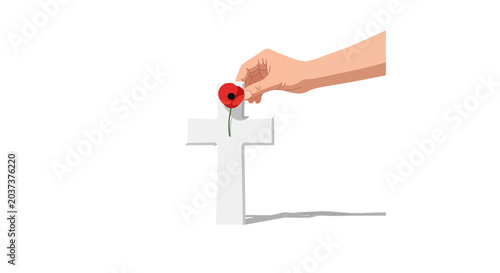 A hand places a poppy on a white cross, symbolizing remembrance and sacrifice for fallen heroes