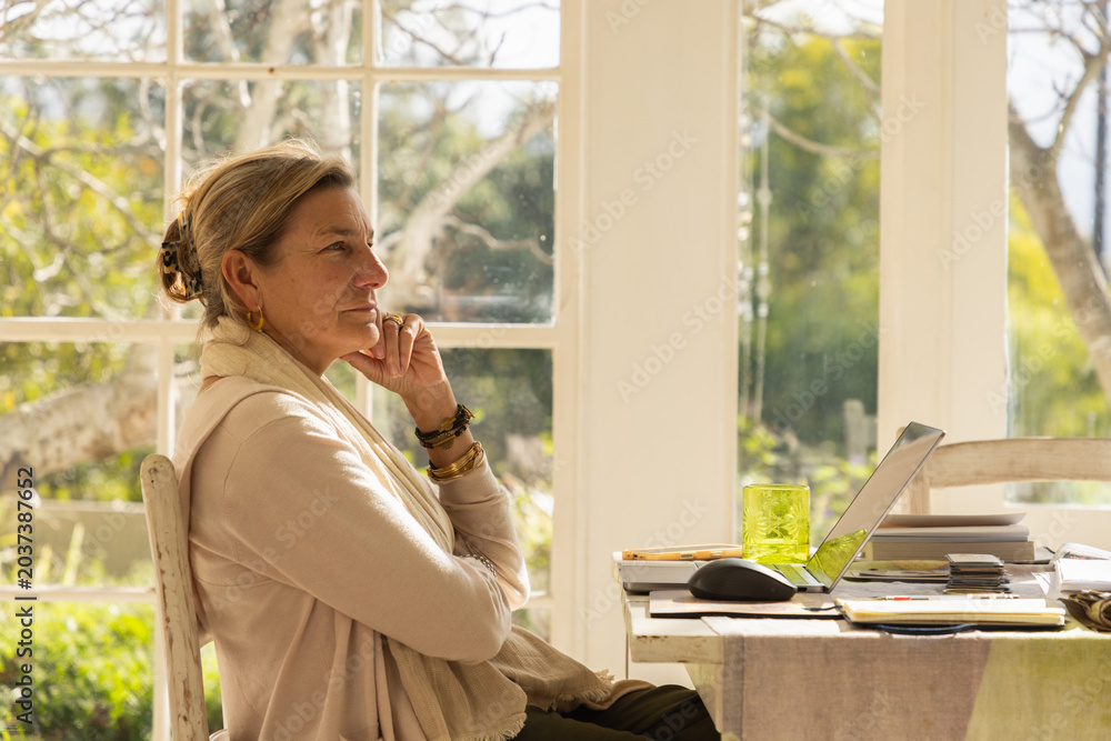 Fototapeta premium profile of adult woman typing in her home office