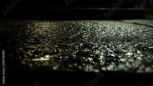Bild auf Leinwand concrete glistening, shining due to reflecting light in the night after it got w