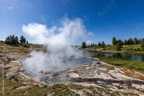 Hot spring emitting steam near Firehole River